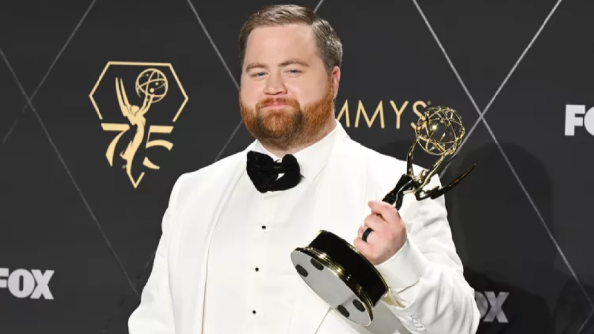 Paul Walter Hauser showing his Emmy award