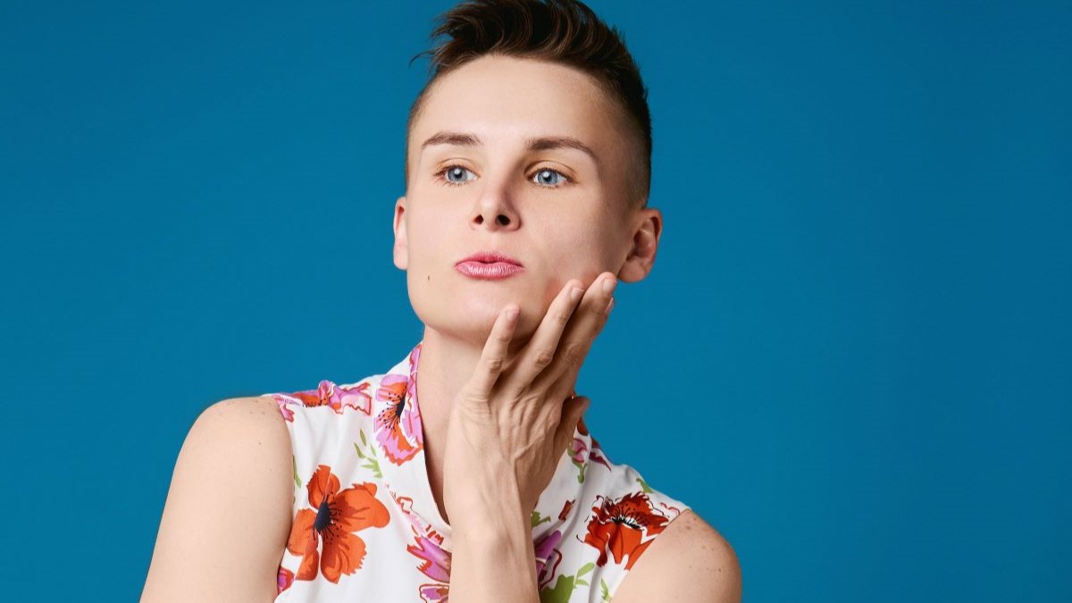 Ashley Gutermuth in floral dress with hand touching face