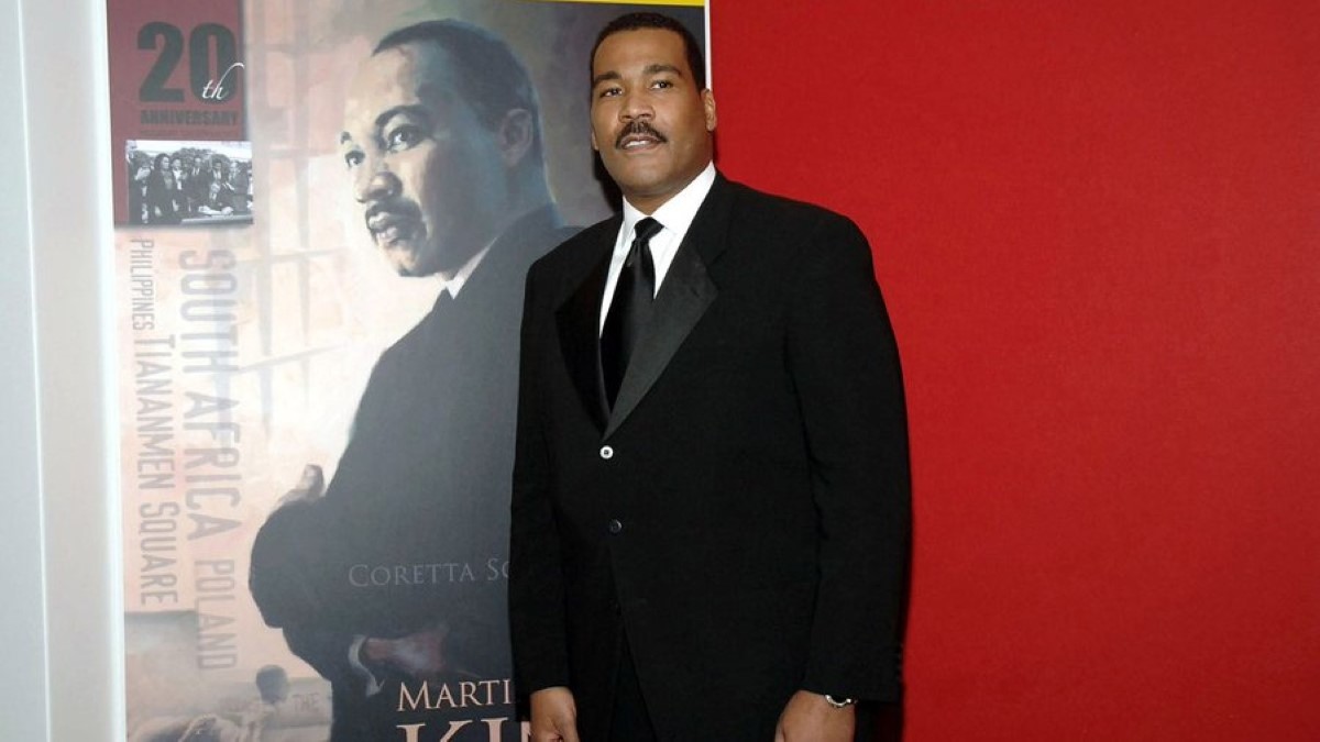 Dexter King poses in a black suit.