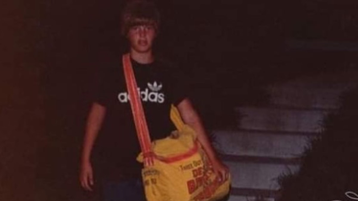 Johnny Gosch carrying a yellow side bag wearing a black t-shirt.