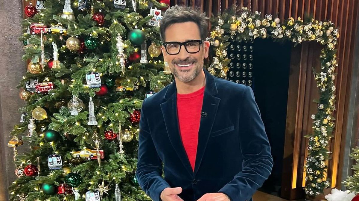 Lawrence Zarian standing front of the Christmas tree.